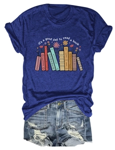 Flat lay of navy book-themed T-shirt with distressed denim shorts on white background