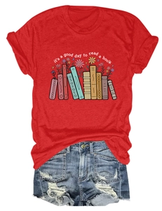 Flat lay of red T-shirt with book illustration and distressed blue denim shorts set