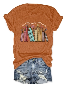 Detail of burnt orange t-shirt with book illustration and its a good day to read text