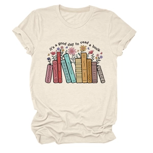 Detailed view of apricot cotton T-shirt featuring colorful books and floral illustration print