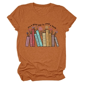 Close-up of rust orange cotton t-shirt featuring artistic book and floral illustration print
