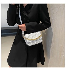 On-body view of a white rectangular crossbody bag with M-letter print and gold chain