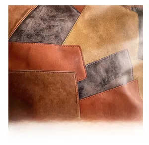 Close-up of vintage leather stitching and patchwork texture on this retro tote bag