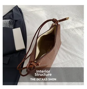 Overhead view of the brown leather shoulder bag interior with cream fabric lining
