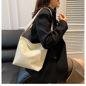 Detail of a large cream hobo bag with geometric patchwork and a comfortable wide strap