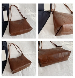 Detail view of brown patchwork leather tote bag showing stitching and knotted shoulder strap
