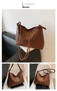 Detail of vintage brown tote bag featuring geometric patchwork and knotted shoulder straps