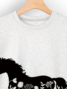 Detail of grey crewneck sweatshirt featuring a black horse silhouette with floral prints