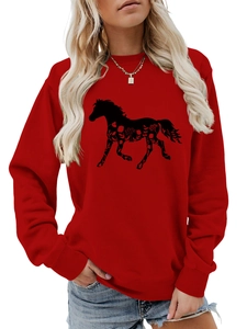 Detail of red crewneck sweatshirt featuring a black horse silhouette with floral patterns
