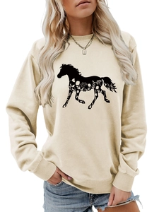 Detail of beige sweatshirt featuring a black horse silhouette with white floral patterns