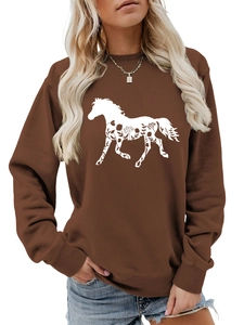 Detail of white horse silhouette with floral patterns on brown long sleeve sweatshirt