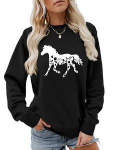 Detail view of the floral horse silhouette print on a black crewneck long sleeve sweatshirt