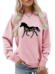 Detail of pink sweatshirt featuring black horse silhouette and white floral patterns