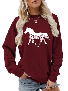 Detail of burgundy sweatshirt featuring a white horse silhouette with floral patterns