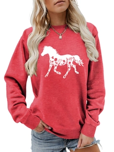 Detail of red crewneck sweatshirt featuring a white horse floral print and ribbed cuffs
