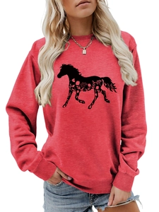 Detail of red crewneck sweatshirt featuring a black floral horse silhouette pattern