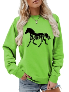 Detail of horse silhouette with floral patterns on neon green long sleeve sweatshirt
