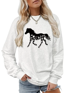 Detail of grey sweatshirt showing black horse silhouette with intricate floral texture