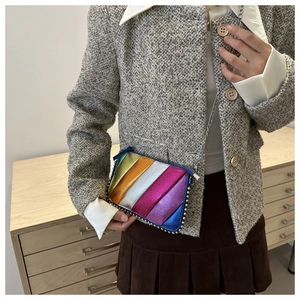 Detail of colorful metallic patchwork shoulder bag with silver rivet studs and chain strap