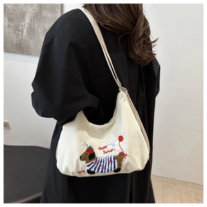 Detail of embroidered dachshund and Happy Summer text on white corduroy tote bag