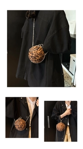 Close-up of leopard print spherical handbag featuring golden ring handle and chain strap