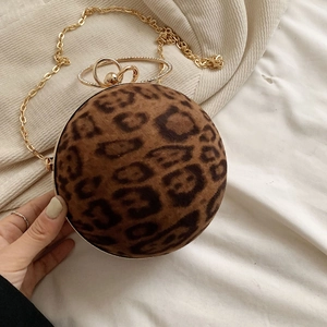 Detail of leopard print ball evening bag featuring golden frame and rhinestone ring handle
