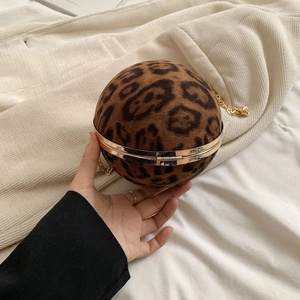 Detail of leopard print spherical evening bag with gold chain strap and metal clasp