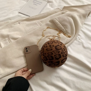 Chic leopard print ball bag next to a smartphone showing compact evening size
