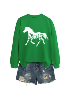 Detail of green long sleeve sweatshirt featuring a floral horse silhouette and denim shorts