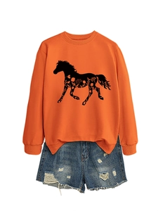 Detail of bright orange sweatshirt with black horse silhouette and floral print