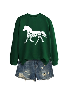 Detail of green sweatshirt with white horse graphic and distressed denim shorts