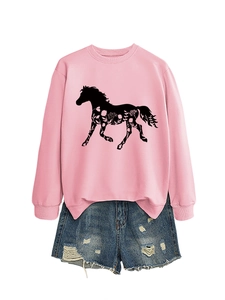 Detail of pink crewneck sweatshirt with horse floral print and distressed denim shorts