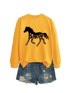 Detail of yellow sweatshirt with horse silhouette and flower print with denim shorts