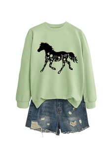Detail of green long-sleeved sweatshirt featuring a horse silhouette with floral patterns