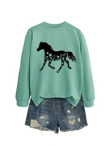 Detail of mint green sweatshirt with horse floral print and ripped denim shorts combo