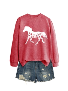 Flat lay of women's red sweatshirt with horse pattern and blue distressed denim shorts