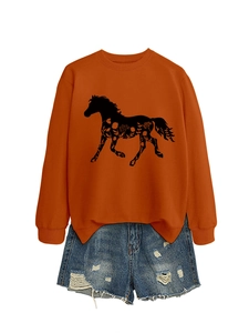 Detail of caramel orange sweatshirt featuring a black horse print with floral texture design