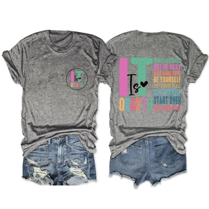 Detail of grey crewneck T-shirt with inspirational text and ripped denim shorts set