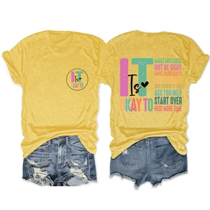 Flat lay set of mustard yellow cotton t-shirts with motivational print and ripped denim shorts