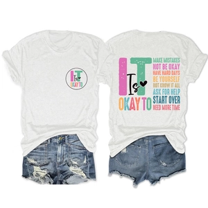 Detail of white cotton T-shirt with inspirational text and ripped denim shorts set