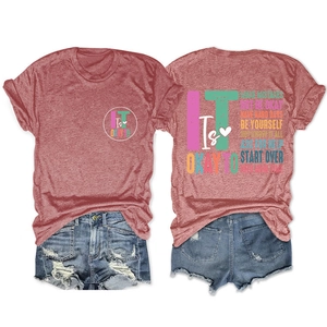 Detail of inspirational quote prints on brick red short sleeve cotton T-shirt