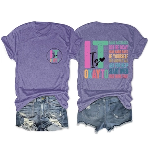 Flat lay of purple cotton blend T-shirt and distressed denim shorts with quote print