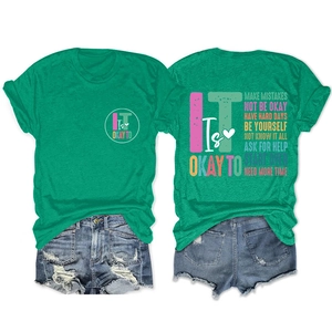 Close-up of distressed motivational lettering on green cotton t-shirt and denim shorts