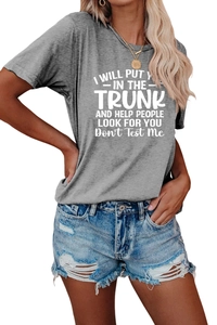 Close-up of a grey crew neck t-shirt with white humor slogan and denim shorts