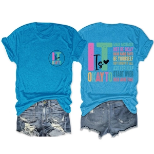 Flat lay of royal blue t-shirt with artistic text and distressed denim shorts set