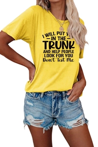 Detail of yellow round neck t-shirt with black letter print and distressed denim shorts