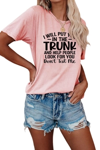 Detail of pink cotton t-shirt with humor slogan and distressed denim shorts