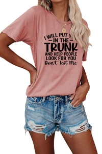 Detail view of a dusty rose cotton T-shirt with black text and blue denim shorts