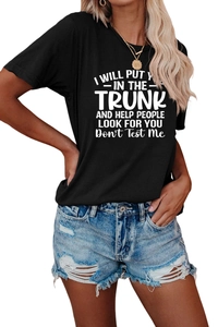 Close-up of black cotton T-shirt with white graphic slogan text and frayed denim shorts