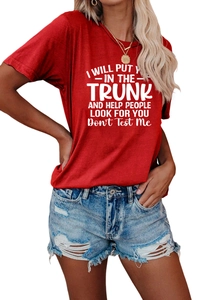 Detail of red crewneck T-shirt with white graphic text slogan and denim shorts